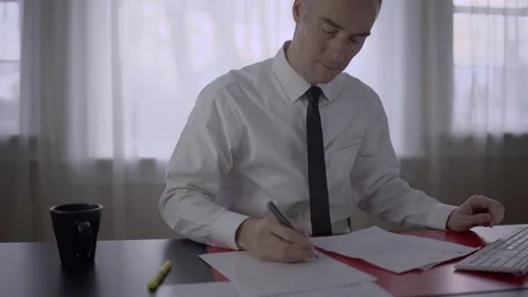 Man doing paperwork in the office Stock Footage 71627758