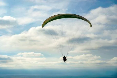 Man doing Para-glider in the clouded sky. Man doing sport, Para-glider in ... 写真素材