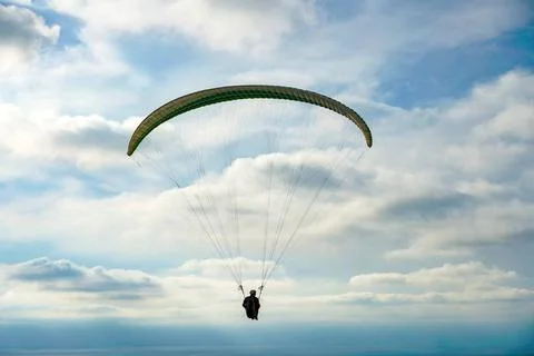 Man doing Para-glider in the clouded sky. Man doing sport, Para-glider in ... 写真素材