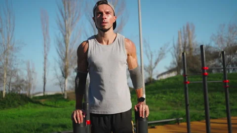 Man doing parallel bar exercises outside Stock-Footage 255575703