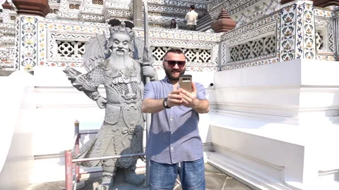 Man doing photo with a sculpture while sightseeing, slow motion shot at 240fps Stock Footage 88159985