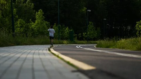 A man is doing physical education walking along a bike path Stock Photos