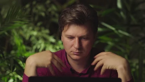 Man doing physical exercises for hands while sitting at the computer Stock Footage 149032041