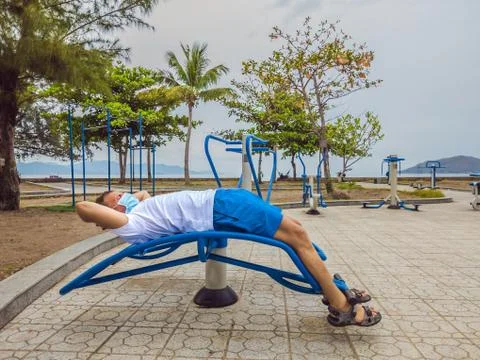 Man doing physical exercises, push ups, strength exercises, leans in empty Stock Photos