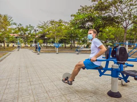 Man doing physical exercises, push ups, strength exercises, leans in empty Stock Photos