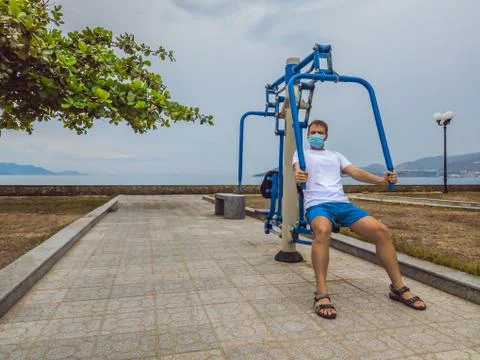 Man doing physical exercises, push ups, strength exercises, leans in empty Stock Photos