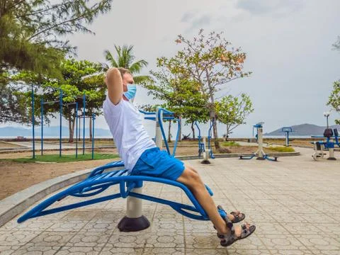 Man doing physical exercises, push ups, strength exercises, leans in empty Stock Photos