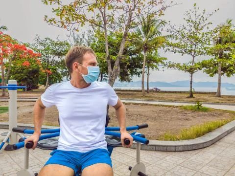 Man doing physical exercises, push ups, strength exercises, leans in empty Stock Photos