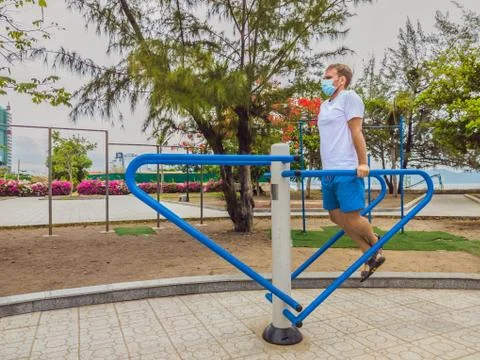Man doing physical exercises, push ups, strength exercises, leans in empty Stock Photos