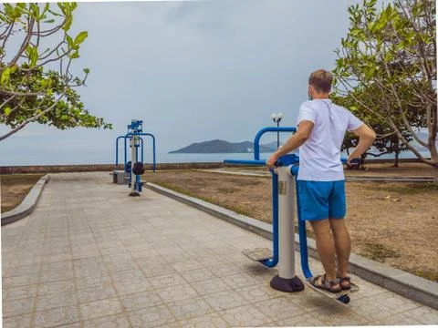 Man doing physical exercises, push ups, strength exercises, leans in empty Stock Photos