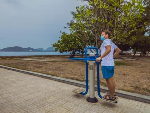 Man doing physical exercises, push ups, strength exercises, leans in empty Stock Photos