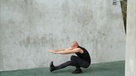 Man doing pistol squats on one leg Stock Footage 67394742