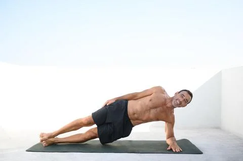Man doing plank exercise on terrace Stock Photos