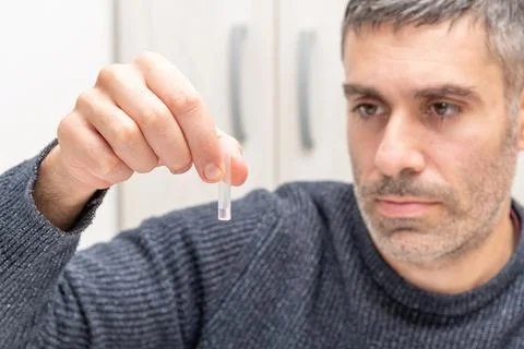 Man doing portable streptococcus bacteria test analysis, patient pours soluti Stock Photos