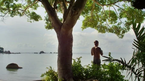 Man doing prayer pose near seaside Stock Footage 74778250