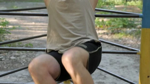 Man doing press on a swedish wall in the park Stock Footage 130268437