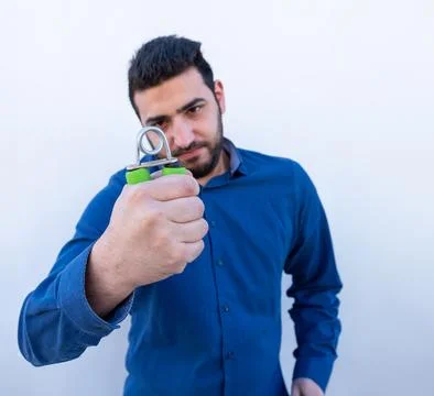 Man doing pressure test and showing his strength on isolated background Stock Photos
