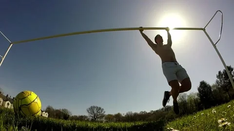 Man doing pull ups on a football goal post, Low angle Video stock 49126214