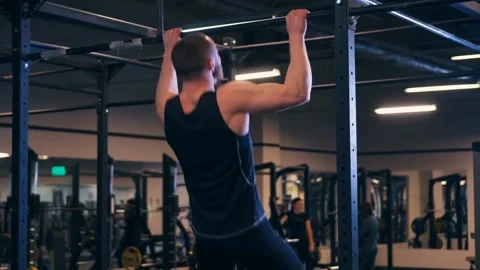Man Doing Pull-Ups in Gym Stock Footage 302630344