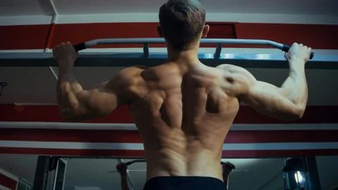 Man doing pull-ups in the gym Stock Photos