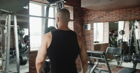 A man is doing pull-ups on a horizontal bar in the gym Video stock 210877355