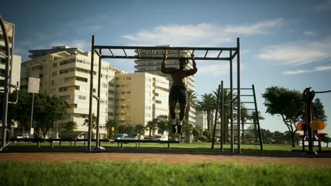 Man doing pull ups in the outdoor gym Stock Footage 279309835
