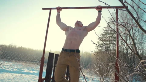 Man doing pull ups sports activities with a naked torso outdoor. Video stock 148491423