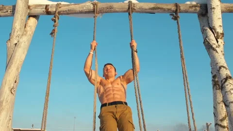 Man doing pull ups sports activities with a naked torso outdoor. Stock-Footage 148492855