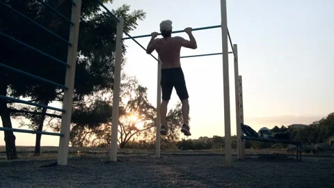 Man Doing Pull Ups On Sports Area Stock Footage 343546025