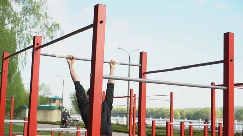 Man doing pull ups using horizontal bar in slow motion. Young male athlete Video stock 130818287