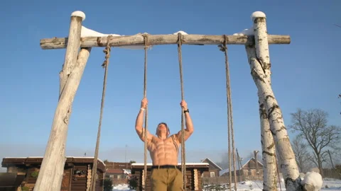 Man doing pull ups utdoors in winter Stock-Footage 147225972