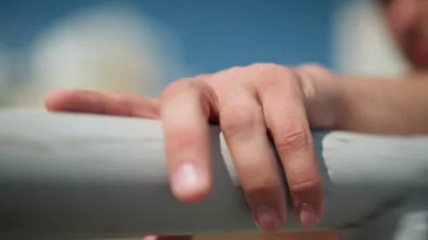 Man doing pullup outside, closeup of hand holding bar during outdoor workout Stock Footage 323505284