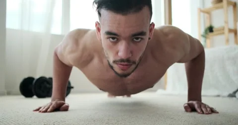 Man doing push up exercise in bedroom Stock Footage 156543782