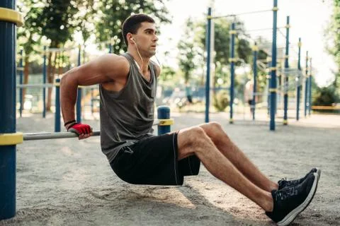 Man doing push-up exercise using horizontal bar 스톡 사진