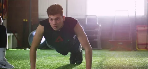 Man doing push-up in fitness studio Stock-Footage 77330756