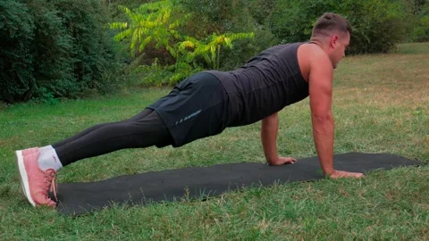 Man doing push ups exercise outdoor. Fit body training workout Stock Footage 146360478