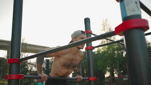 Man doing push ups exercises on parallel bars Stock-Footage 236647710