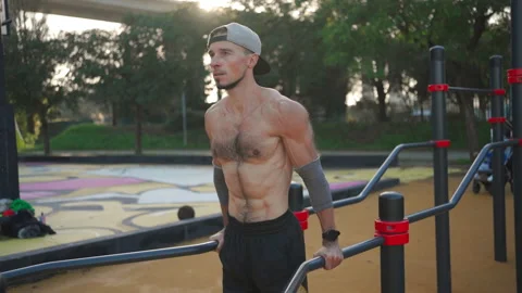 Man doing push ups exercises on parallel bars Stock-Footage 237249286