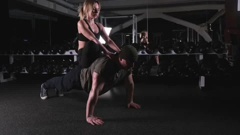 Man doing push-ups with a girl on his back 库存影片 170478223