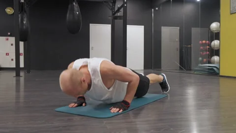Man doing push ups in a gym. Perfect for fitness and workout Stock Footage 141982131
