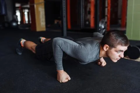 A man doing push-UPS in the gym, sports, push-UPS on weights Stock Photos