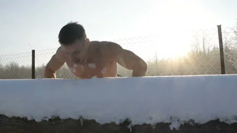 Man doing push ups outdoors in winter Stock Footage 147226161