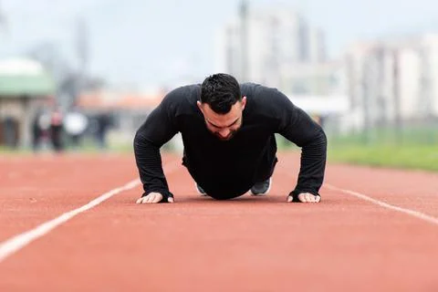 Man Doing Push Ups on Track Stock Photos