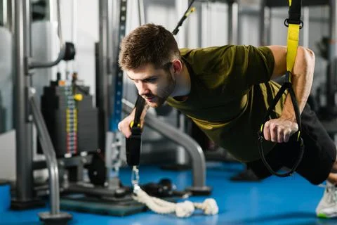 Man doing push ups with trx fitness straps Stock Photos
