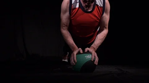 Man doing Push-ups using one medball, resting on it with two hands.Isolated on a Stock Footage 124898682