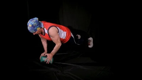 Man doing Push-ups using one medball, resting on it with two hands.Isolated on a Stock Footage 125006668
