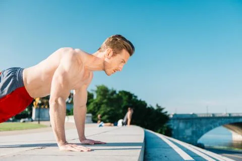Man doing pushups outdoors Stock Photos