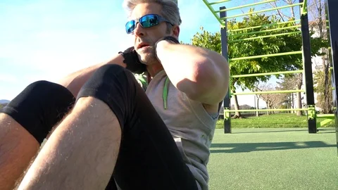 Man doing pushups outside on training ground Stock Footage 72091764