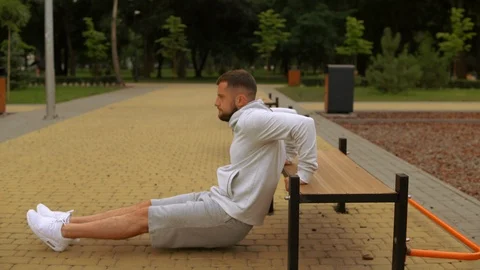 Man is doing reverse push-ups Stock Footage 93821349