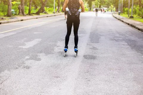 Man doing roller skating exercise in the park. Stock Photos